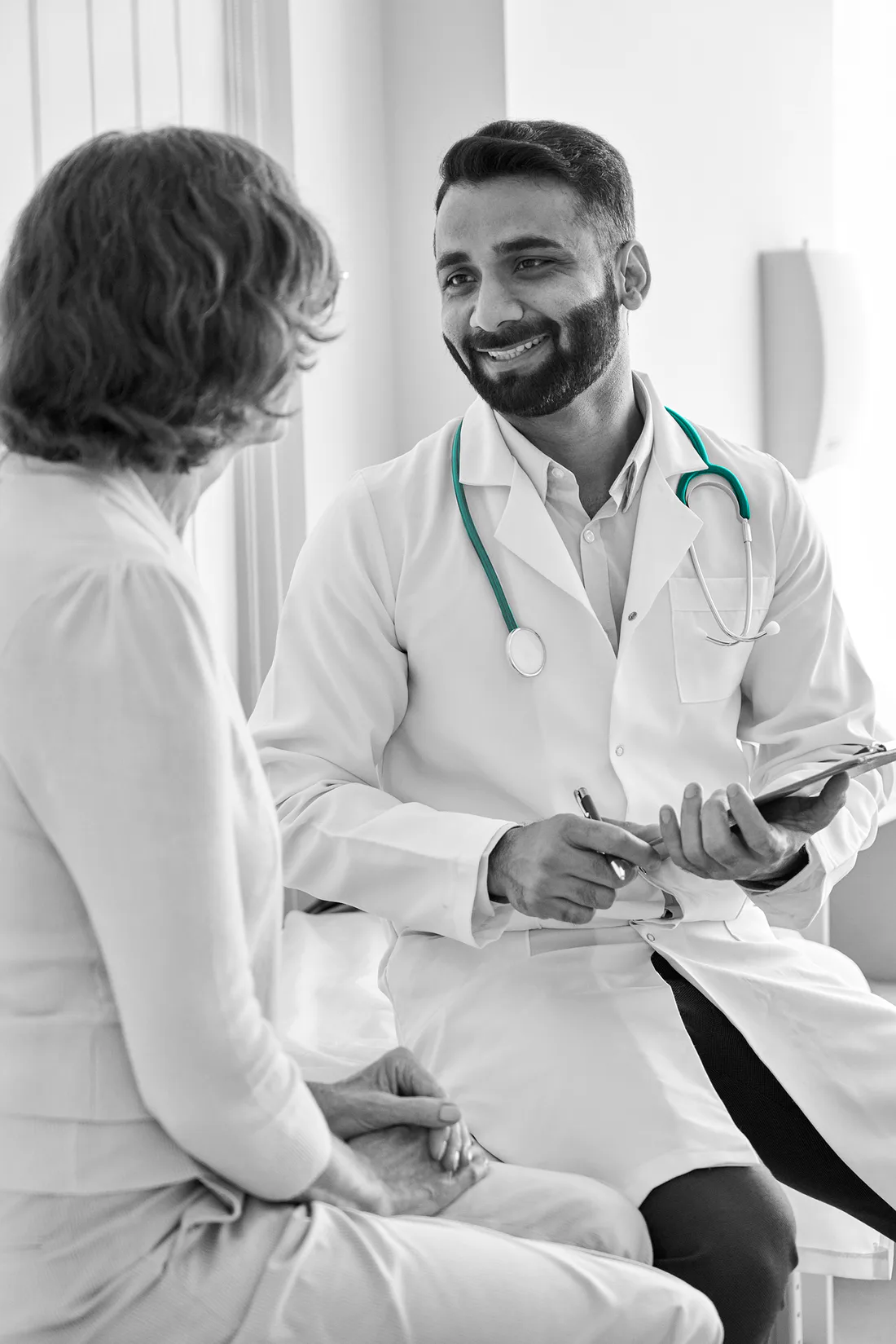 A physician talking with a patient during an office visit