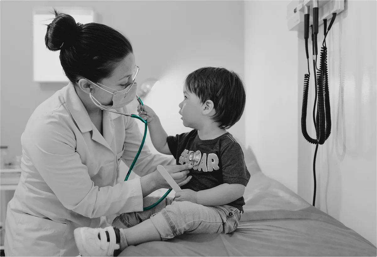 A physician examining a young child during a routine visit